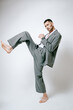 © Elina Leonova - Fashion man model in grey suit, barefoot, shoot in studio