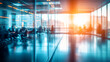 © Michael - Blurred interior of a modern office building with business people working behind glass walls
