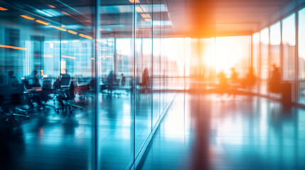 Poster - Blurred interior of a modern office building with business people working behind glass walls