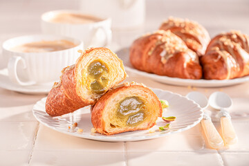 Wall Mural - Tasty and fresh pistachio croissants with nut filling.