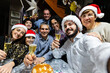 © Xavier Lorenzo - Multi-generation family taking selfie portrait toasting with champagne during christmas dinner celebration at home