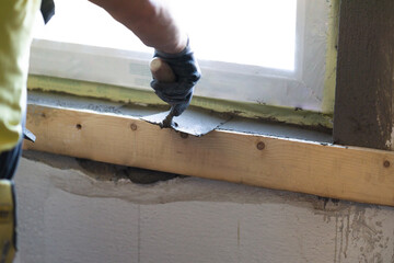 Construction worker working with trowel