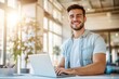 © kitipol - High-resolution brightly lit photorealistic candid photograph of a young marketer in casual attire, smiling while working on his laptop in a bright office. The photograph is styled like a high-end