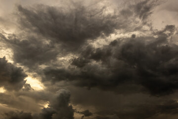 Dramatic stormy sky with dark clouds. Nature background at sunset