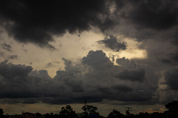 Dramatic stormy sky with dark clouds. Nature background at sunset