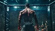 © 99 RIC - Muscular male MMA fighter in cage, viewed from behind, his back glistening with sweat under dim lights.