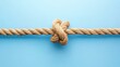 © CrazyJuke - A closeup view of a strong knotted rope connection against a blue backdrop, showcasing unity and strength.