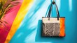 © Boonnam Burart - A fashionable tote bag hanging on a hook, with vibrant patterns and colors adding a splash of style to a minimalist room