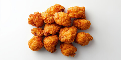 A delicious pile of golden, crispy fried chicken pieces on a white background, enticing and ready to be enjoyed as a tasty meal or snack.