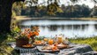 © nurionstudio - A picnic blanket with a delicious spread of food and drinks set out under a tree near a lake.