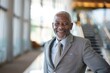 © LadiesWin - Portrait of successful senior Zulu businessman consultant looking at camera and smiling inside modern office building , background blur