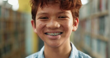 Aufkleber - Braces, education and face of kid in library for child development, learning or scholarship. Books, portrait and reading with smile of happy learner, pupil or student at school for knowledge or study
