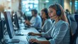 © phattharabodin - A customer service agent working in a call center, wearing a headset and typing on a computer, surrounded by other agents.