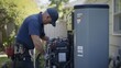 © phattharabodin - An electrician installing a backup generator system in a residential home.