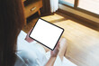 © Farknot Architect - Top view mockup image of a woman holding digital tablet with blank desktop screen on the bed