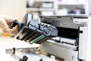 Technician Holding ink printer toner low for replace new or fix repair problem paper or print scanning fax or copy document or photocopier or photocopy office workplace equipment concept