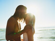 © StarDweller/peopleimages.com - Couple, kiss and love on beach outdoor for romance date, sea water and support of tropical vacation. Happy, woman and man with embrace for loyalty, travel together and holiday journey of summer peace