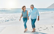 © KayExam/peopleimages.com - Love, holding hands and walking with old couple at beach for travel destination, summer and anniversary vacation. Relax, tropical and retirement with senior people for holiday, bonding and romance