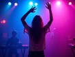 © Hannes - Silhouette of woman dancing in club with vibrant stage lights and live band in background