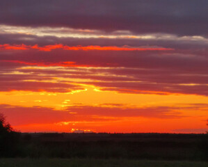 The sky is orange and the sun is setting