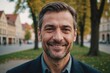 © ThomasLENNE - Close portrait of a smiling 40s Hungarian man looking at the camera, Hungarian outdoors blurred background