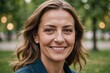 © ThomasLENNE - Close portrait of a smiling 40s Hungarian woman looking at the camera, Hungarian outdoors blurred background