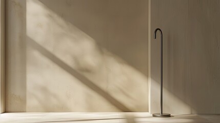 Canvas Print - Taupe backdrop with a shadow of a sleek umbrella stand creating a simple touch