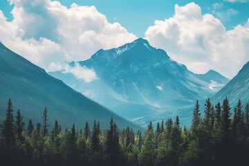 A majestic mountain peak with snow capped summit rises above a dense evergreen forest.