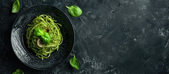 Canvas Print - Homemade Spinach Mushroom Pesto Spaghetti On A Plate On A Black Background Top View Flat Lay Overhead From Above Copy Space