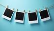 © Jittiwan - Clothesline with arranged blank black polaroid photo prints in the clothespins isolated on blue background, mockup design concept