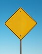 © Jittiwan - Blank yellow road sign mockup against blue sky