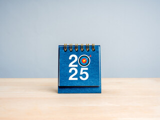 Poster - happy new year 2025 minimal banner. 2025 number with target bullseye icon on blue small desk calenda