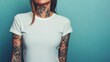 © Galib - A tattooed woman wearing a white t-shirt.