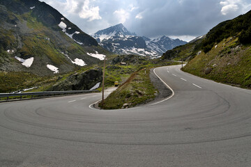 Winding road of Flüela Pass offering breathtaking views of the Swiss Alps and connecting Davos with Susch amidst scenic mountains