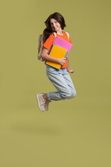 Poster - Cute teenage girl with backpack and books jumping on olive background