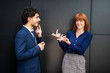 © Minerva Studio - Business people using sign language having a conversation outside office building