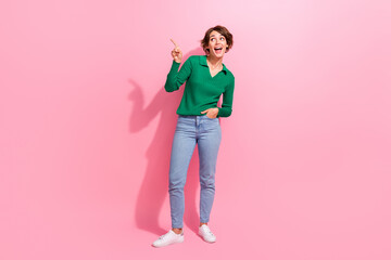 Sticker - Full body length shot of young lady point finger empty space interesting information customers purchase isolated on pink color background