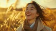 © ifoto - A woman smiles and looks up at the sky, her hair blowing in the wind as she stands on an open field with tall grasses under golden sunlight.