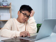 © Thawatchai Images - Boy using computer for learning and stressed about online learning, Virtual internet online class from school teacher by remote meeting, Homeschooling and education concept, online education concept.