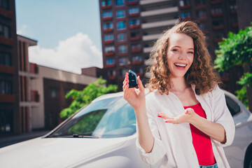 Canvas Print - Photo of cheerful cute adorable girl buying new car hold key wear white shirt enjoying free time sunny weather outdoors modern city