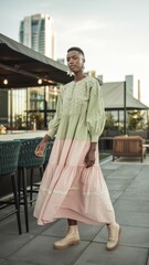 Poster - Elegant Model in Green and Pink Tiered Dress with Soft Fabrics