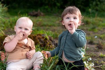 Boys on the shore in the green grass have a picnic