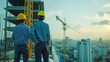 © liliyabatyrova - Two men wearing hard hats stand on a construction site