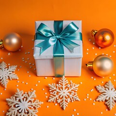 A gift box with a red ribbon. Next to it is a Christmas tree ball and some snowflakes