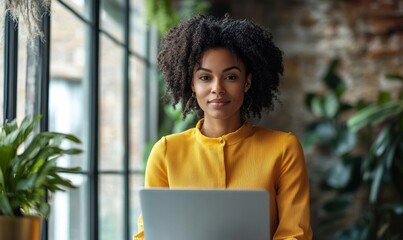 Confident Young Black Woman Working on Laptop in Modern Office during Daylight, Professional Entrepreneur in Yellow Blouse, Urban Loft Workspace, Business and Technology, Generative AI