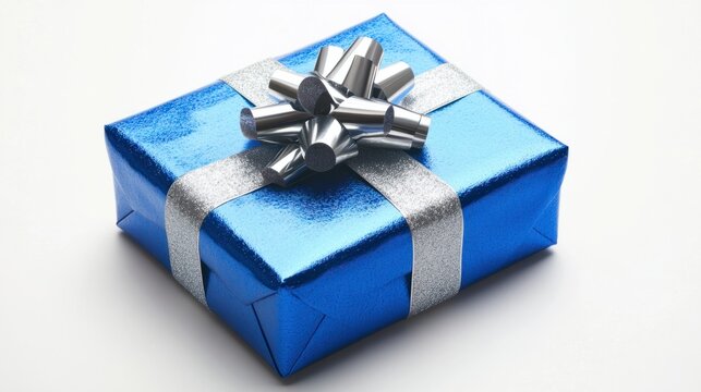 Elegant blue New Year present wrapped in metallic paper with a silver ribbon, isolated on a white background, perfectly tied bow.