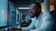 © stardadw007 - A focused individual coding in front of dual monitors displaying complex programming languages in a modern office setting.