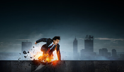 Wall Mural - Determined businessman leaving fire trails on asphalt