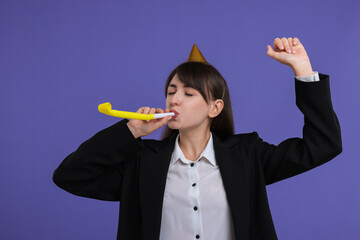 Canvas Print - Woman in party hat with blower on purple background