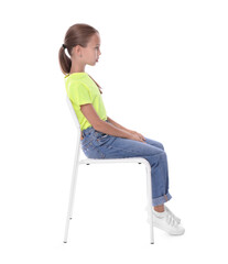 girl with correct posture sitting on chair against white background